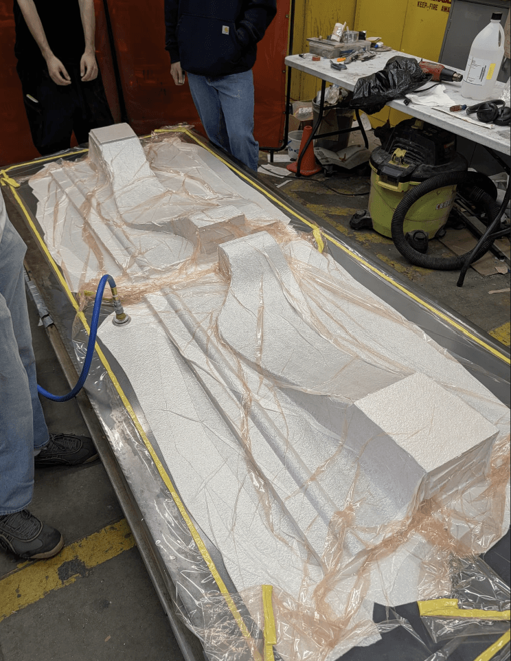 Undertray core under vacuum for debulking